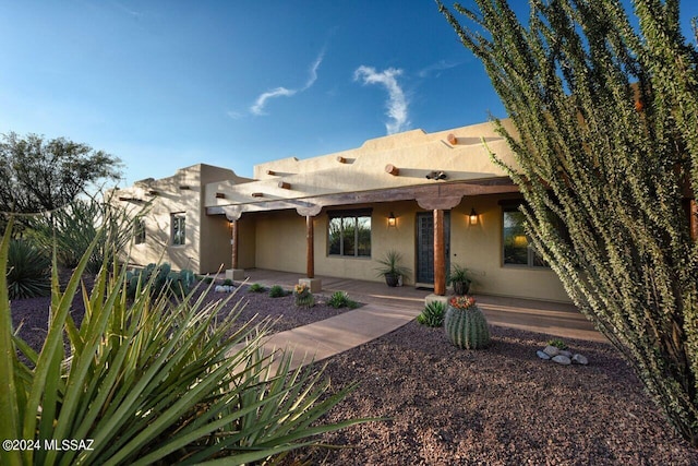 pueblo-style home with a patio area