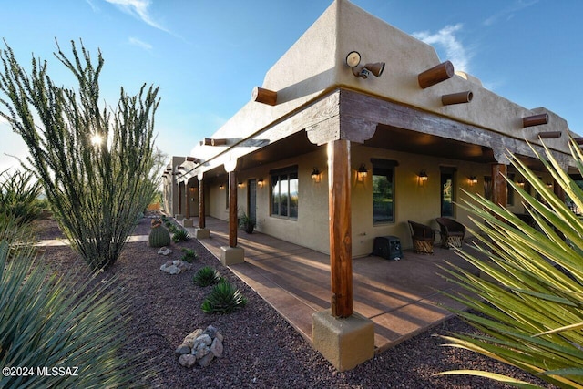 view of side of home with a patio