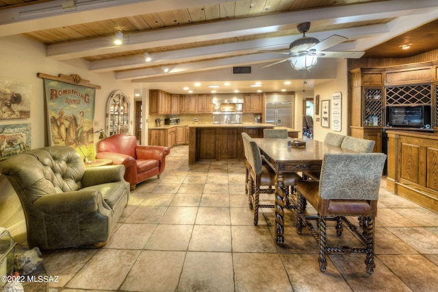 dining area with beamed ceiling, ceiling fan, and wood ceiling