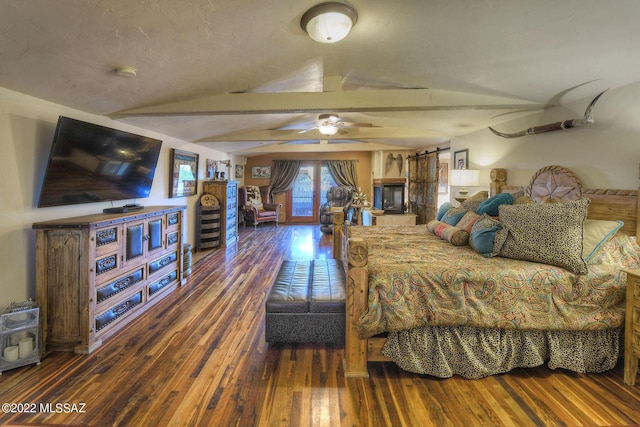 bedroom with a barn door, dark wood-type flooring, and lofted ceiling with beams