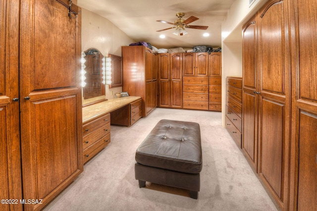 interior space with ceiling fan, light colored carpet, and lofted ceiling