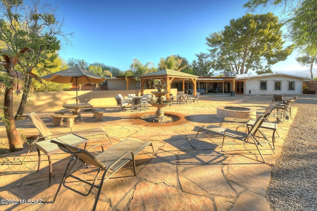 view of patio / terrace with a gazebo and a fire pit