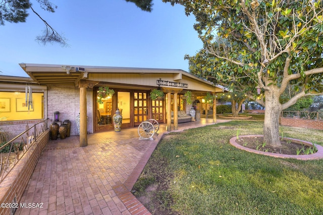 exterior space featuring a yard and a patio area