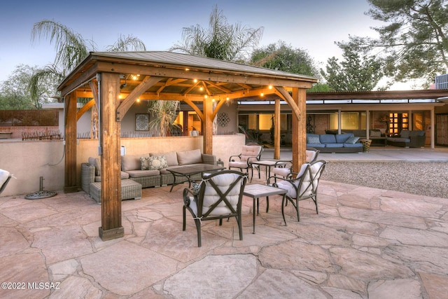 patio terrace at dusk with a gazebo and an outdoor hangout area