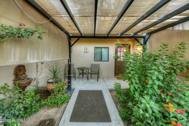 property entrance with a pergola