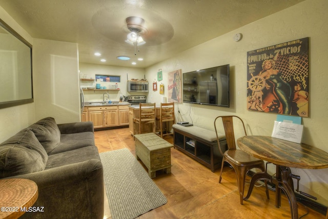 living room featuring ceiling fan and sink