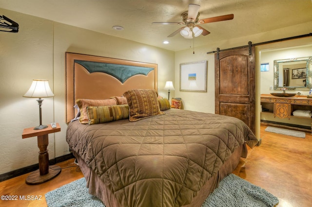 bedroom with a barn door and ceiling fan