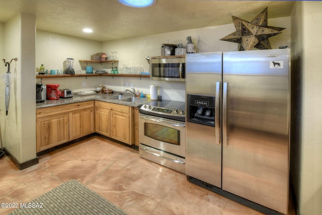 kitchen with sink and appliances with stainless steel finishes