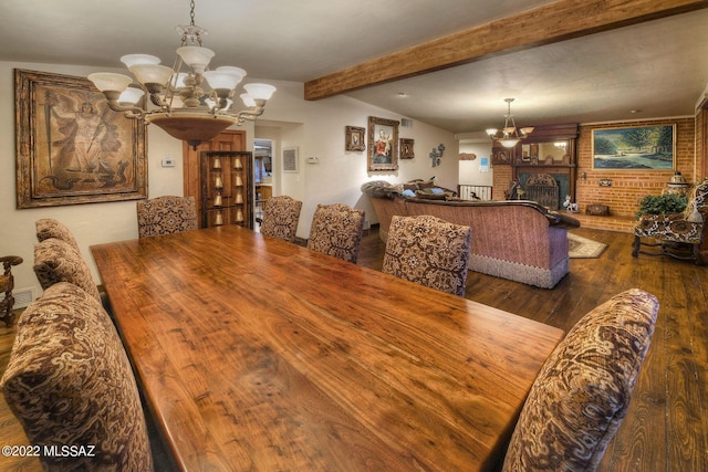 dining area featuring dark hardwood / wood-style flooring, a fireplace, lofted ceiling with beams, and an inviting chandelier