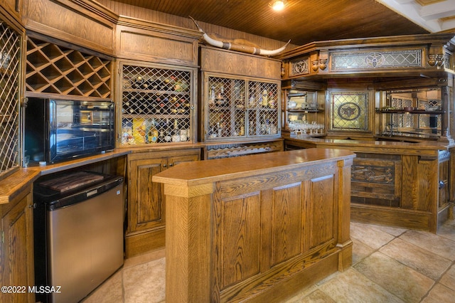 interior space with wood ceiling and indoor bar