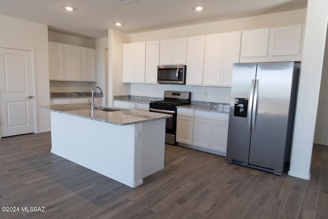 kitchen featuring appliances with stainless steel finishes, white cabinetry, sink, and dark hardwood / wood-style floors