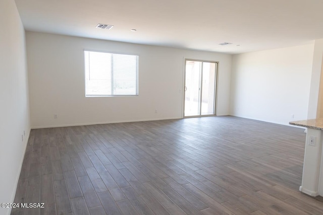 spare room with dark hardwood / wood-style floors