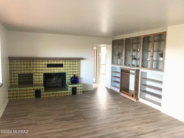 unfurnished living room with a fireplace and wood-type flooring