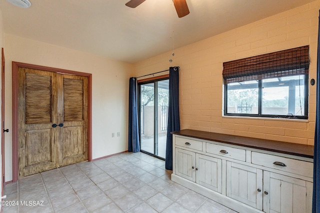 interior space featuring ceiling fan and baseboards