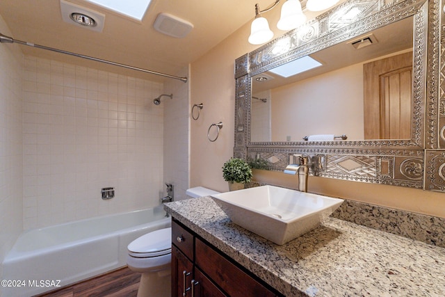 full bath featuring shower / bathing tub combination, vanity, toilet, and wood finished floors