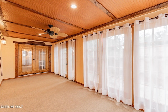 unfurnished sunroom with ceiling fan and wooden ceiling