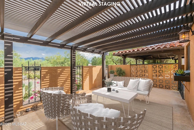 wooden deck featuring a pergola, an outdoor hangout area, and a patio