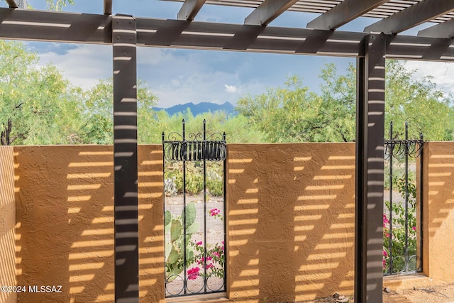 view of gate with fence and a pergola