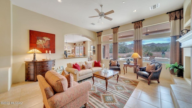 living room with light tile patterned floors and ceiling fan