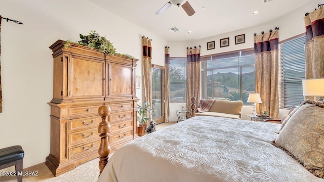 bedroom with ceiling fan and light carpet