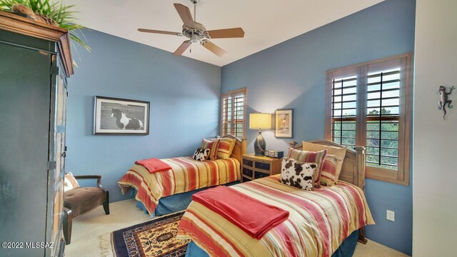 carpeted bedroom featuring ceiling fan