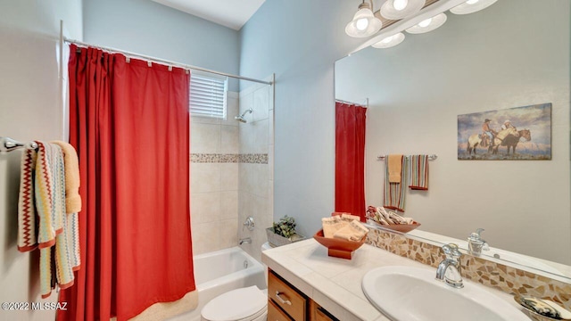 full bathroom with shower / bathtub combination with curtain, vanity, and toilet