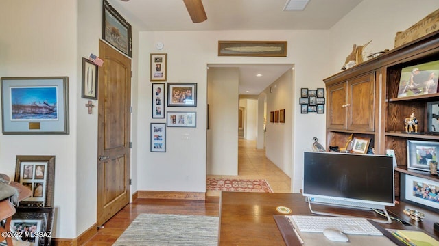 tiled office space with ceiling fan