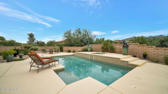 view of swimming pool featuring an in ground hot tub and pool water feature