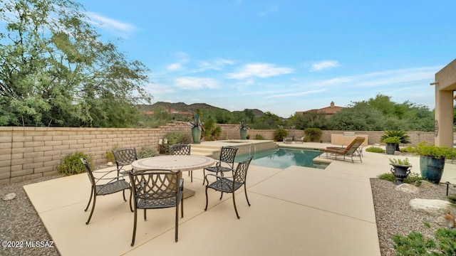 view of pool with a mountain view and a patio area