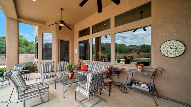 view of patio / terrace with a mountain view, an outdoor hangout area, and ceiling fan