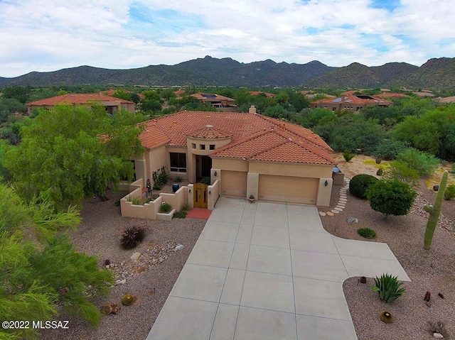 mediterranean / spanish-style home featuring a mountain view and a garage