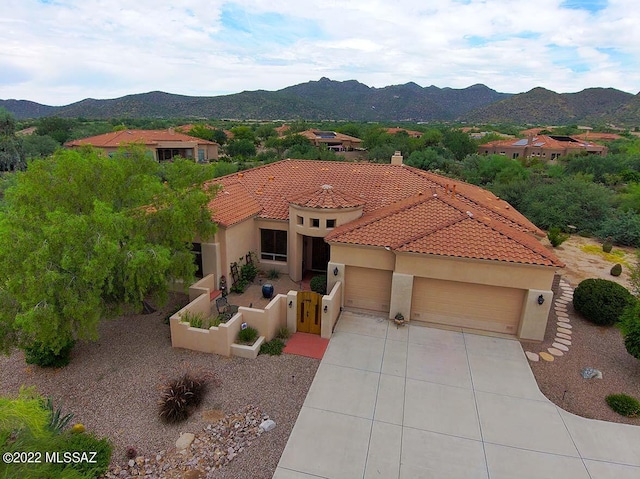 mediterranean / spanish house featuring a mountain view and a garage