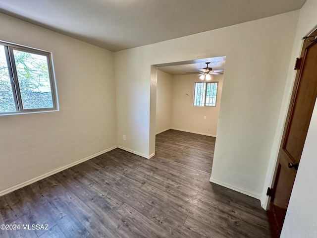 empty room featuring dark hardwood / wood-style floors and ceiling fan