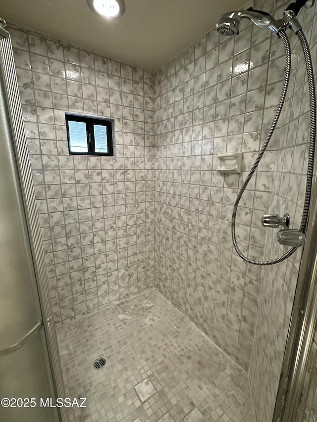 bathroom with tiled shower