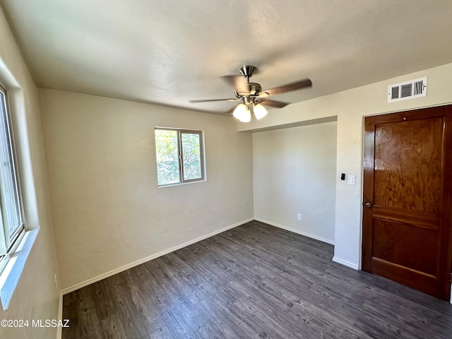 unfurnished room featuring dark hardwood / wood-style floors and ceiling fan