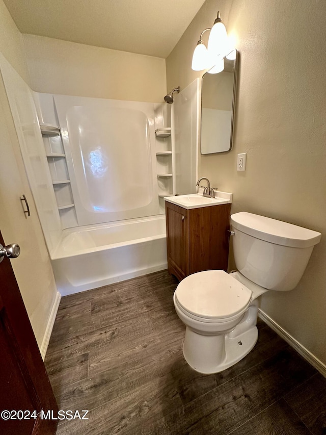 full bathroom featuring wood-type flooring, toilet,  shower combination, and vanity