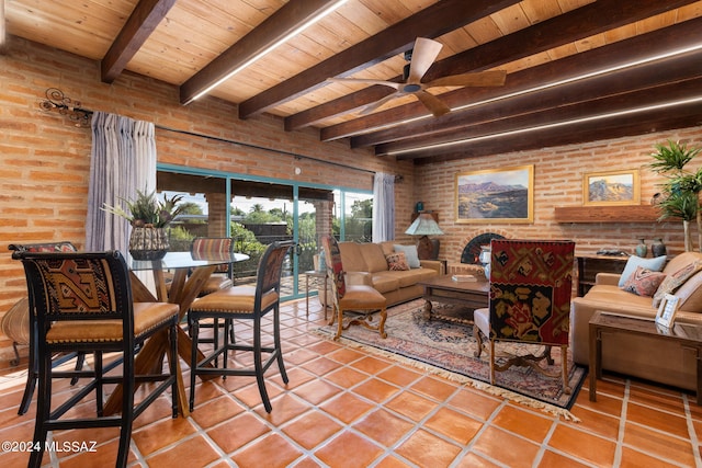 living room featuring wood ceiling, tile patterned flooring, brick wall, and beamed ceiling