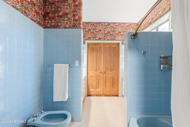 bathroom featuring tile walls and a bidet