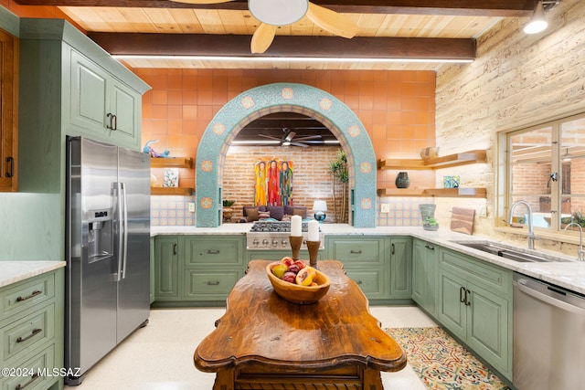 kitchen featuring appliances with stainless steel finishes, beam ceiling, sink, and green cabinets