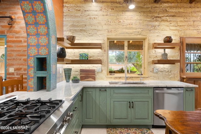 kitchen featuring light stone countertops, appliances with stainless steel finishes, sink, and a healthy amount of sunlight