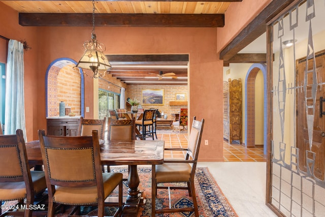 tiled dining area featuring ceiling fan with notable chandelier, wood ceiling, and beam ceiling