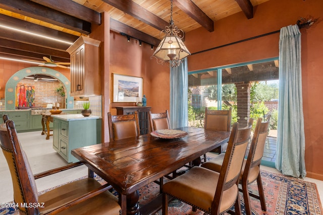 dining space with rail lighting, wood ceiling, beam ceiling, and ceiling fan