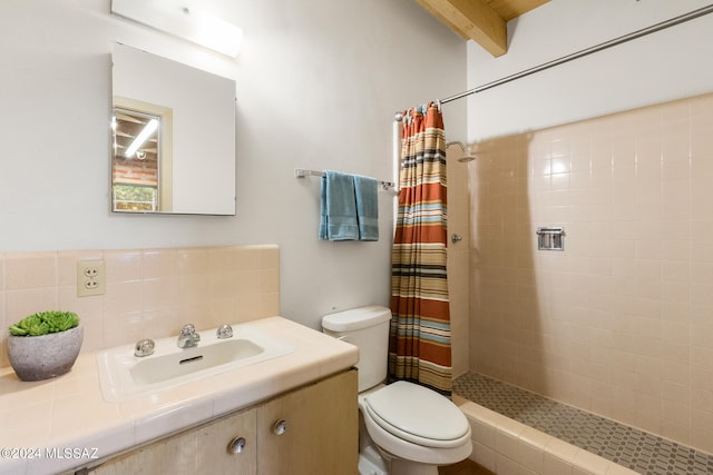 bathroom featuring a shower with shower curtain, beamed ceiling, vanity, and toilet