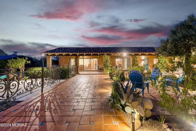 view of patio terrace at dusk