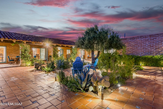 view of patio terrace at dusk