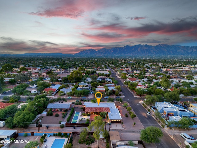 aerial view at dusk featuring a mountain view