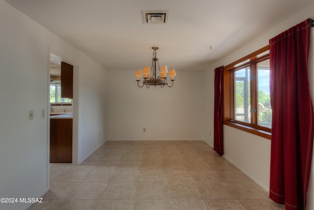 empty room with an inviting chandelier