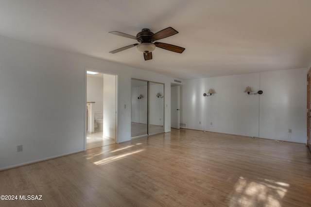 empty room featuring ceiling fan and light hardwood / wood-style flooring