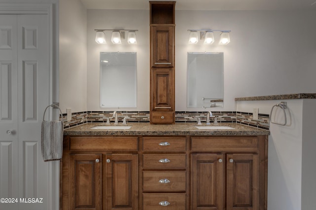 bathroom featuring vanity and decorative backsplash