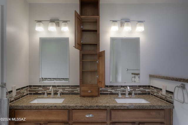 bathroom with vanity and decorative backsplash